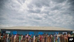 FILE - Rohingya Muslims, who crossed over from Myanmar into Bangladesh, wait in queues to receive aid at Kutupalong refugee camp in Ukhiya, Bangladesh.