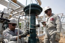 FILE - Oil workers conduct routine maintenance on a gas plant at field Boscan, operated under a joint venture model between Venezuelan state oil company PDVSA and U.S. Chevron, outside Maracaibo City in Venezuela, May 26, 2006.