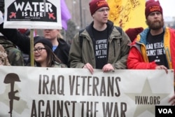 Protesters speak out against the war — and in support of water — as Donald Trump is sworn-in as the 45th President of the United States in Washington, D.C., Jan, 20, 2017. (Victoria Macchi/VOA)