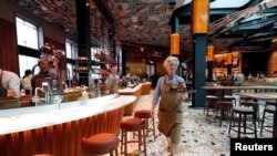Employees work inside the new Starbucks Reserve Roastery flagship in downtown Milan, Italy, Sept. 4, 2018. 