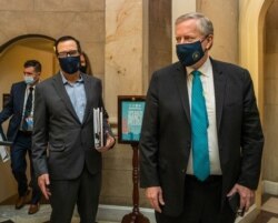 FILE - White House chief of staff Mark Meadows, right, and Treasury Secretary Steven Mnuchin arrive at the office of House Speaker Nancy Pelosi at the Capitol to resume talks on a COVID-19 relief bill, Aug. 1, 2020, in Washington.