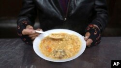 A man eats his soup during "La Porciuncula," a religious event where Franciscans monks serve food to the poor, at the Los Descalzos Convent in Lima, Peru, Aug. 2, 2017.