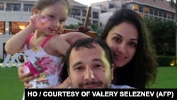 FILE - Moscow accused Washington of "abducting" Russian national Roman Seleznyev, center, after he was arrested in the Maldives on suspicion of being one of the world's most prolific traffickers of stolen credit card details in 2014.