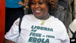 A woman smiles as she celebrates Liberia being an Ebola-free nation in Monrovia, Liberia, Saturday, May 9, 2015. Liberia is now free of Ebola after going 42 days — twice the maximum incubation period for the deadly disease — without any new cases, the World Health Organization announced on Saturday.(AP Photo/ Abbas Dulleh)