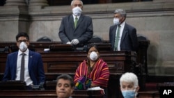 Lawmakers wearing face masks as a precaution against the spread of COVID-19 attend a session in Congress, in Guatemala City, Wednesday, March 18, 2020. (AP Photo/Moises Castillo)