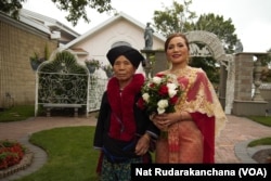 Chuthaphorn Sricharoenta in a red Thai dress made by Thunyatorn Ng.