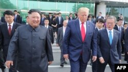This picture taken on June 30, 2019 and released by North Korea's official Korean Central News Agency (KCNA) on July 1, 2019 shows North Korea's leader Kim Jong Un (L) meeting South Korea's President Moon Jae-in (R) and US President Donald Trump. 