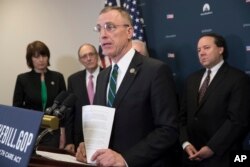 FILE - Rep. Tim Murphy, R-Pa., center, speaks on Capitol Hill in Washington, March, 17, 2017.