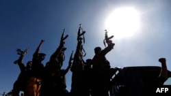 FILE - Newly recruited Houthi fighters chant slogans as they ride a military vehicle during a gathering in the capital Sanaa, Jan. 3, 2017. The Biden administration has suspended sanctions on the rebel group.