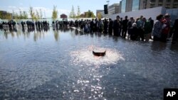 Visitors gather during the dedication ceremony of the American Veterans Disabled for Life Memorial Sunday, Oct. 5, 2014, in Washington.(Sammy Dallal/Invision for American Veterans Disabled For Life Memorial/AP Images)