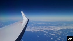 Japan Coast Guard's Gulfstream V aircraft flies in the search zone for debris from the missing Malaysia Airlines flight MH370, April 1, 2014 off Perth, Australia.
