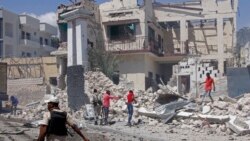 Rescuers and security forces sift through wreckage at the scene of a blast in Mogadishu, Somalia, Jan. 12, 2022.