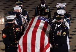 Justice Ruth Bader Ginsburg's flag-draped casket leaves the Statuary Hall at the Capitol