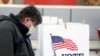 FILE - Voter Fred Hoffman fills out his ballot during the primary election in Ottawa, Illinois, March 17, 2020. 
