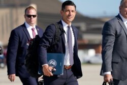 Acting-Secretary of Homeland Security Chad Wolf, center, arrives to join President Donald Trump at Andrews Air Force Base in Md., Aug. 18, 2020.