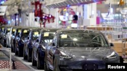 Tesla China-made Model 3 vehicles are seen during a delivery event at its factory in Shanghai, China, Jan. 7, 2020. 