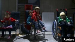 FILE - Children wait to be examined from Unicef health workers in Kafra Batna in the Damascus suburb of eastern Ghouta, Syria, Oct. 30, 2017. 
