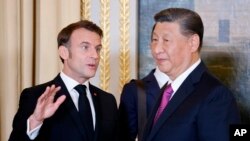 Presiden Prancis Emmanuel Macron berbicara dengan Presiden ChinP Xi Jinping saat makan malam kenegaraan di Istana Elysee di Paris, Senin, 6 Mei 2024. Perancis. (Foto: melalui AP)