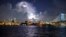 Lightning illuminates storm clouds over the Philadelphia skyline, Tuesday, August 16, seen from across the Delaware River in Camden, New Jersey.