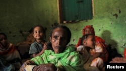 Fatuma Hussein, 65, sits in her shelter with her family at a camp for the internally displaced due to the fighting between the Ethiopian National Defense Force (ENDF) and the Tigray People's Liberation Front (TPLF) forces in Dessie town, Amhara region, Ethiopia, October 8, 2021. 