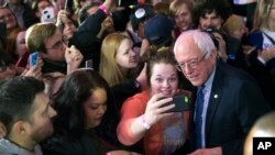 Le candidat démocrate sénateur Bernie Sanders pose pour des photos lors d'un rassemblement de nuit de caucus à Des Moines, Iowa, 1er février 2016.