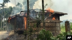 FILE - Houses are on fire in Gawdu Zara village, northern Rakhine state, Myanmar, Sept. 7, 2017.