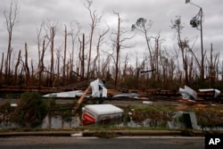 Shredded trees, derailed train cars and a sunken trailer are seen in the aftermath of Hurricane Michael in Panama City, Fla., Oct. 10, 2018.