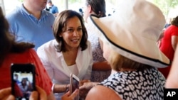 Democratic presidential candidate Sen. Kamala Harris greets local residents during the West Des Moines Democrats' annual picnic, July 3, 2019, in West Des Moines, Iowa. 