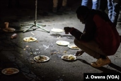 Migrants and refugees have dinner near the underpass in Ventimiglia, Italy. Many wait until nightfall to attempt their crossing in France.