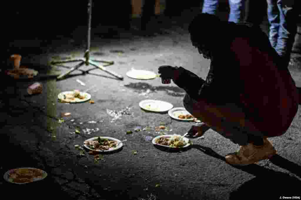 Migrants and refugees have dinner near the underpass in Ventimiglia, Italy. Many wait until nightfall to attempt their crossing in France.