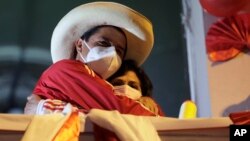 FILE - Pedro Castillo hugs his wife Lilia Paredes Navarro as he stands before supporters at his closing campaign rally in Lima, Peru, June 3, 2021. Mexico recently announced that it has granted asylum to Paredes Navarro and other members of Castillo's family. 