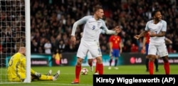 England's Jamie Vardy, center, and Raheem Sterling, right, celebrate after Vardy scored his side's second goal passing Spain's goalkeeper Jose Reina, left, during the international friendly soccer match between England and Spain at the Wembley stadium.