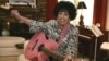 FILE - In this May 19, 2009, file photo, Wanda Jackson plays a pink guitar in her home in Oklahoma City.