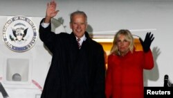 US Vice President Joe Biden (L) and his wife Jill wave upon their arrival at Boryspil International airport outside Kyiv November 20, 2014.