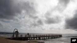 A worker secures a dock before Hurricane Delta is due to arrive near Playa del Carmen, Mexico, Oct. 6, 2020.