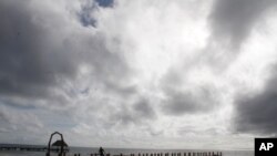 A worker secures a dock before Hurricane Delta is due to arrive near Playa del Carmen, Mexico, Oct. 6, 2020.
