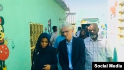 Sudanese health official Iman Mahmoud, left, talks to U.N. humanitarian chief Mark Lowcock, center, during his visit to Kassala, eastern Sudan, Nov. 23, 2019, in a photo posted on Twitter by @UNOCHA_Sudan.