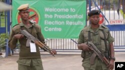 FILE - Armed police officers stand guard outside the presidential election results center in Lusaka, Zambia, Jan, 21, 2015.