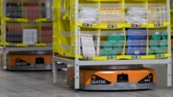 In this Dec. 5, 2018, photo, pods full of merchandise are moved around the floor by robotic drives, named Amazon robots, at the Amazon fulfillment center on Staten Island borough of New York. (AP Photo/Mary Altaffer)