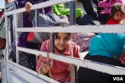 A Sunni Muslim girl beams as she heads out of Mosul, Nov. 3, 2016. (Photo: Jamie Dettmer for VOA)