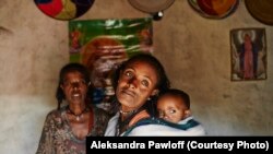 FILE - Mebrit Kasua and one of her children at her home in the Tigray Province of northern Ethiopia. A new study says a newly launched national ambulance service has halved pregnancy-related births in the country.