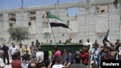 Chinese health workers collect bags of dead chickens at Huhuai wholesale agricultural market in Shanghai.