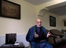 FILE - Former Afghan President Hamid Karzai speaks during an interview with the Associated Press at his house, in Kabul, Afghanistan, June 20, 2021.