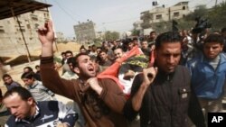 Palestinians carry the body of 12-year-old boy Ayoub Assaleya during his funeral in Jabalya in the northern Gaza Strip, March 11, 2012.