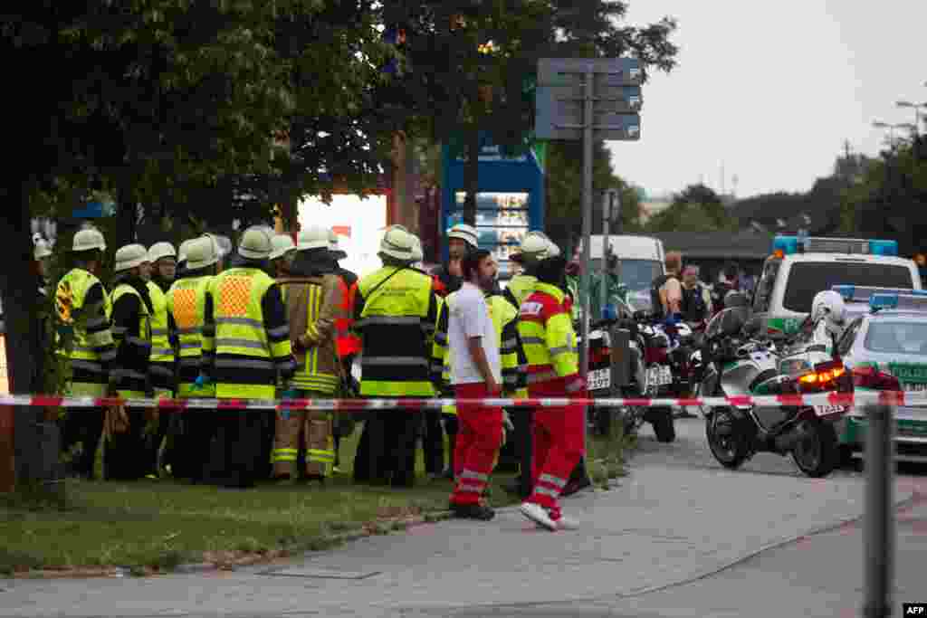 Firefighters stand near a shopping mall (the Olympia Einkaufzentrum (OEZ) ) in Munich on July 22, 2016 following shootings.