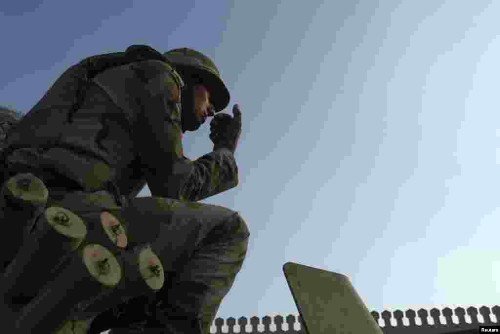 An Egyptian soldier keeps watch from atop a military vehicle in front of the presidential palace in Cairo, July 14, 2013. 