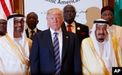President Donald Trump poses for photos with King Salman, right, and others at the Arab Islamic American Summit, at the King Abdulaziz Conference Center, May 21, 2017, in Riyadh, Saudi Arabia.