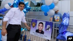 A poster photo of San Antonio police Officer Miguel Moreno is placed at a make-shift memorial, June 30, 2017, in San Antonio. Moreno died of wounds suffered when he and his partner were shot by a man they intended to question about a vehicle break-in.