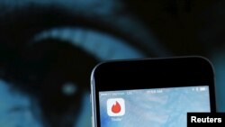 FILE - The dating app Tinder is shown on an Apple iPhone. 