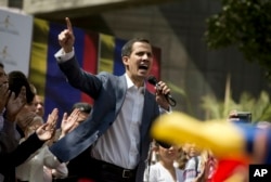 FILE - Juan Guaido, president of the Venezuelan National Assembly delivers a speech during a public session with opposition members, at a street in Caracas, Venezuela, Jan. 11, 2019.